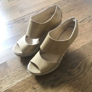 Nude Jimmy Choo platform sandals.